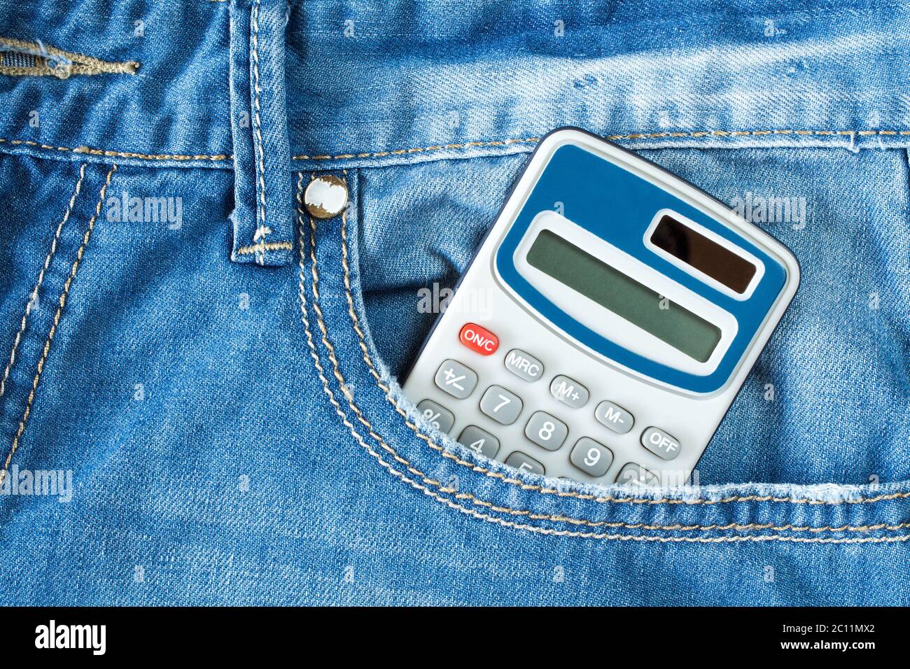 Calculator in jeans pocket Stock Photo - Alamy