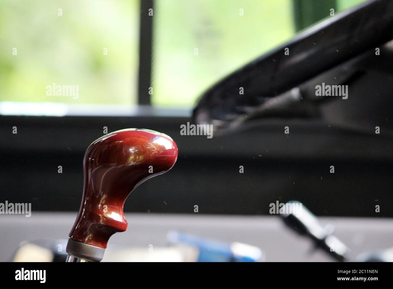Manual gear box handle and hand wheel against the window in a big tour bus close up Stock Photo