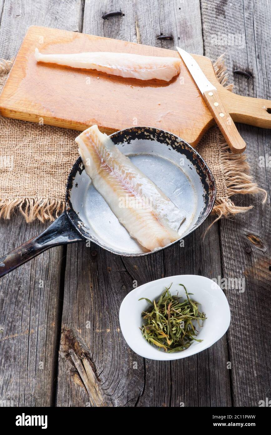 raw fish fillets for frying on pan. kitchen composition Stock Photo - Alamy