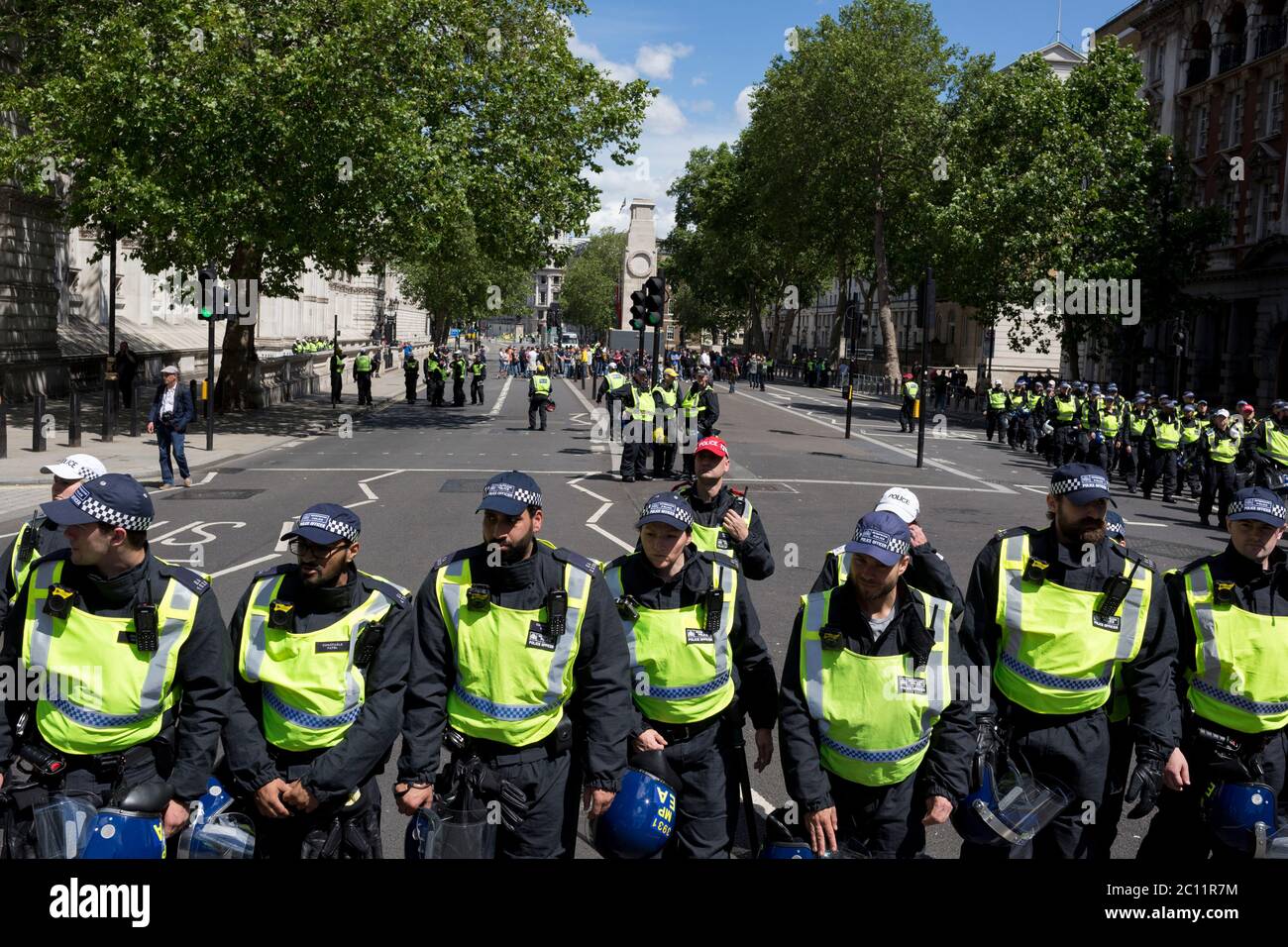 A week after a Black Lives Matter protest turned to violence when the statue of wartime Prime Minister Sir Winston Churchill was daubed in graffiti which called him a racist, and despite warning from police not to attend protests at all today - and to be off the streets by 5.00pm - a large group crowd of right-wing groups and veterans gathered at the boxed-in statue to 'protect it from further vandalism' by Black Lives Matter and anti-racism protesters. Riot police stopped the right-wing groups from proceeding up Whitehall where the Cenotaph was also behind a screen, resulting in scuffles, on Stock Photo