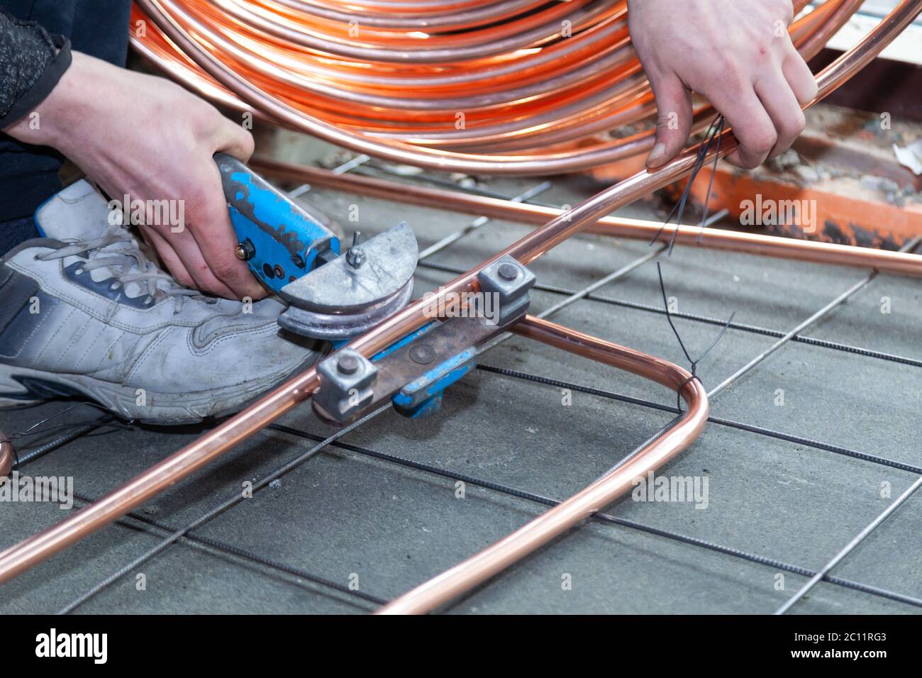 male hands bends copper pipes by pipe bender Stock Photo Alamy