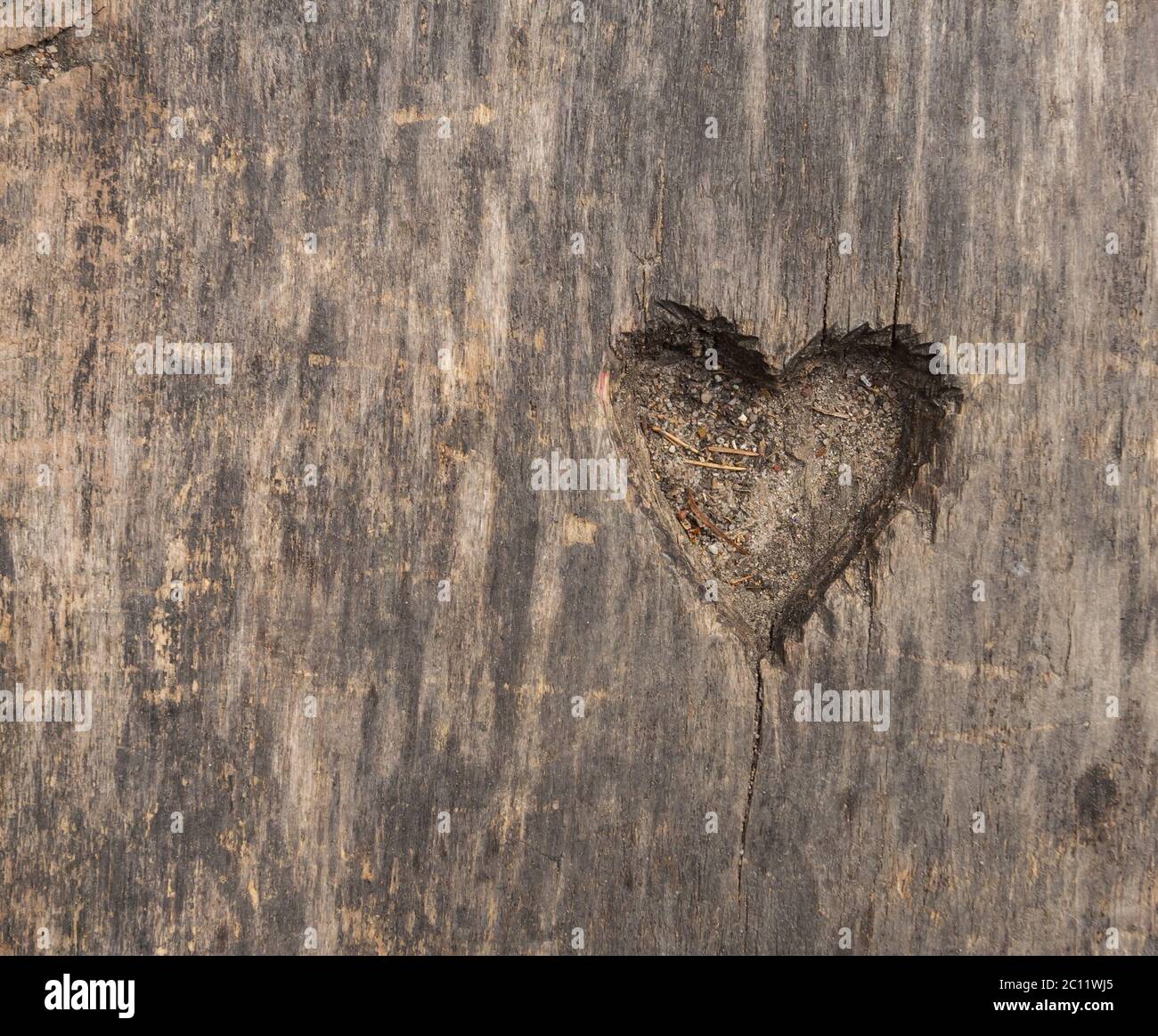 Small heart shape cut in old wood. Picture useful as background Stock Photo