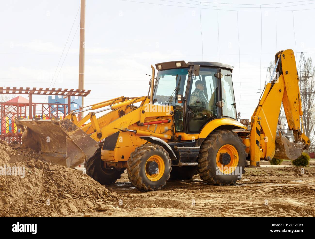 Working excavator tractor digging a trench for pipenlineat at