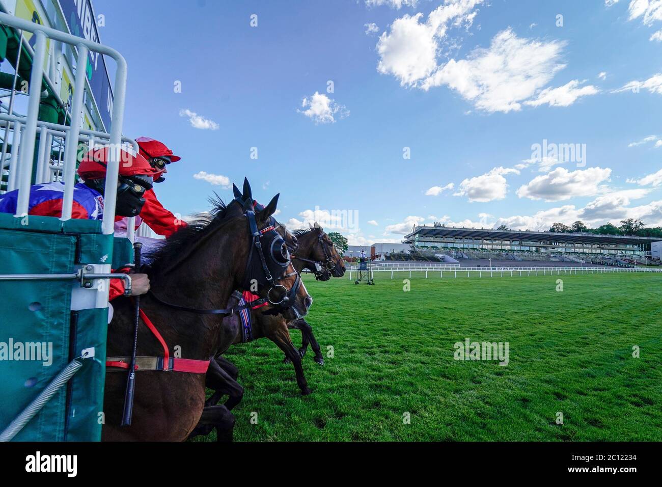 A general view as runners leave the stalls in The Oxshott Handicap at Sandown Park Racecourse. Stock Photo