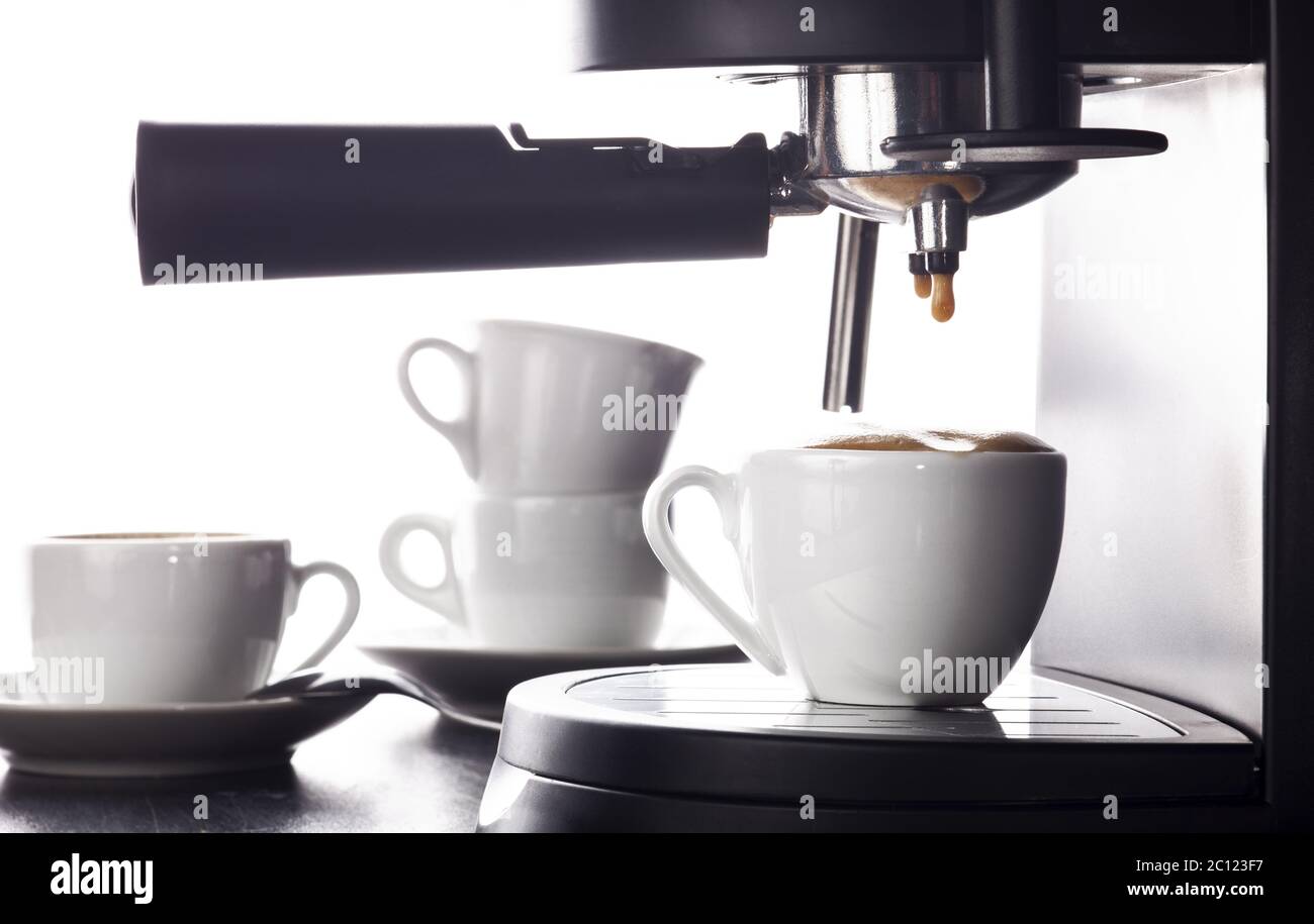 Espresso pouring from coffee machine Stock Photo Alamy
