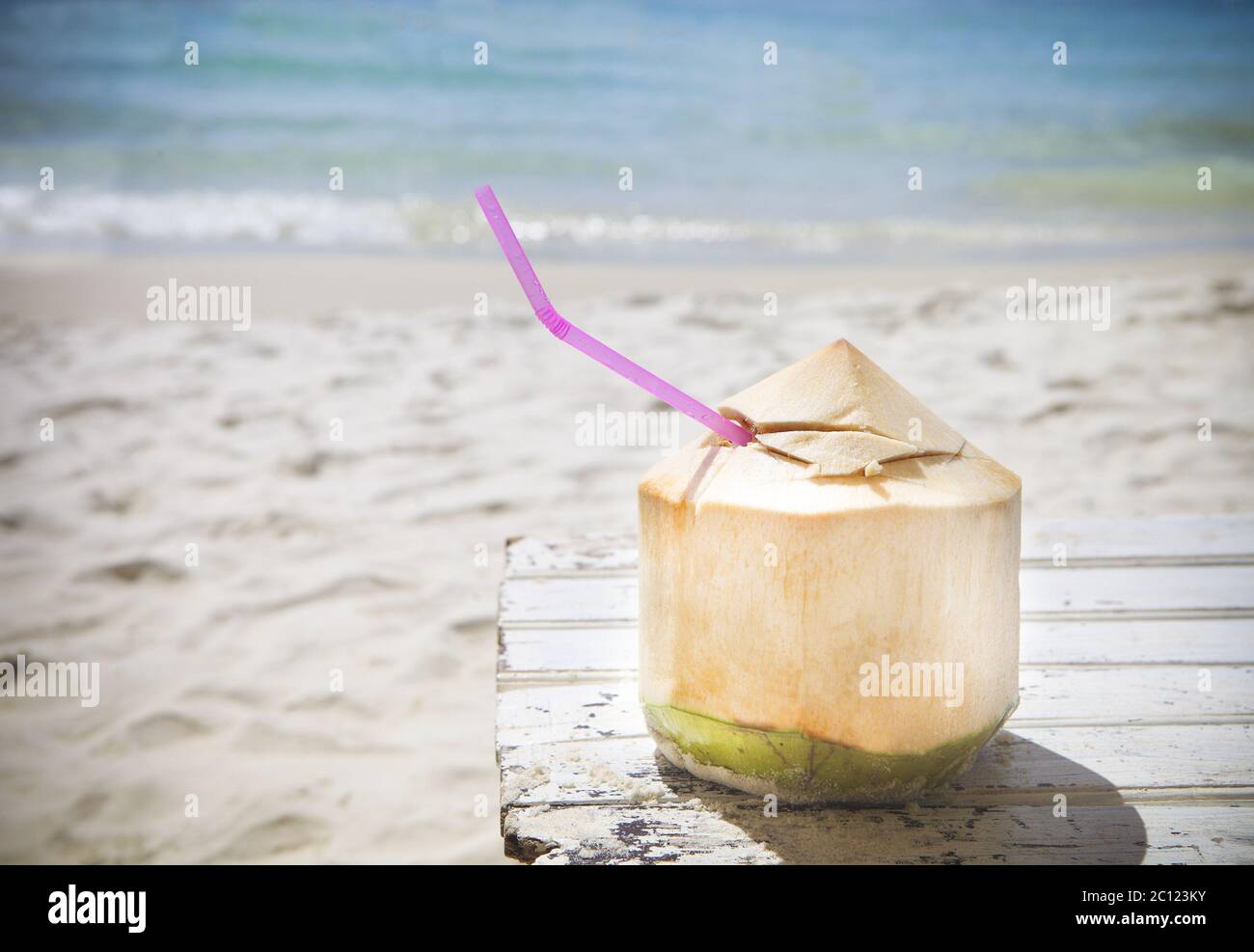 Fresh coconut cocktail on tropical beach Stock Photo