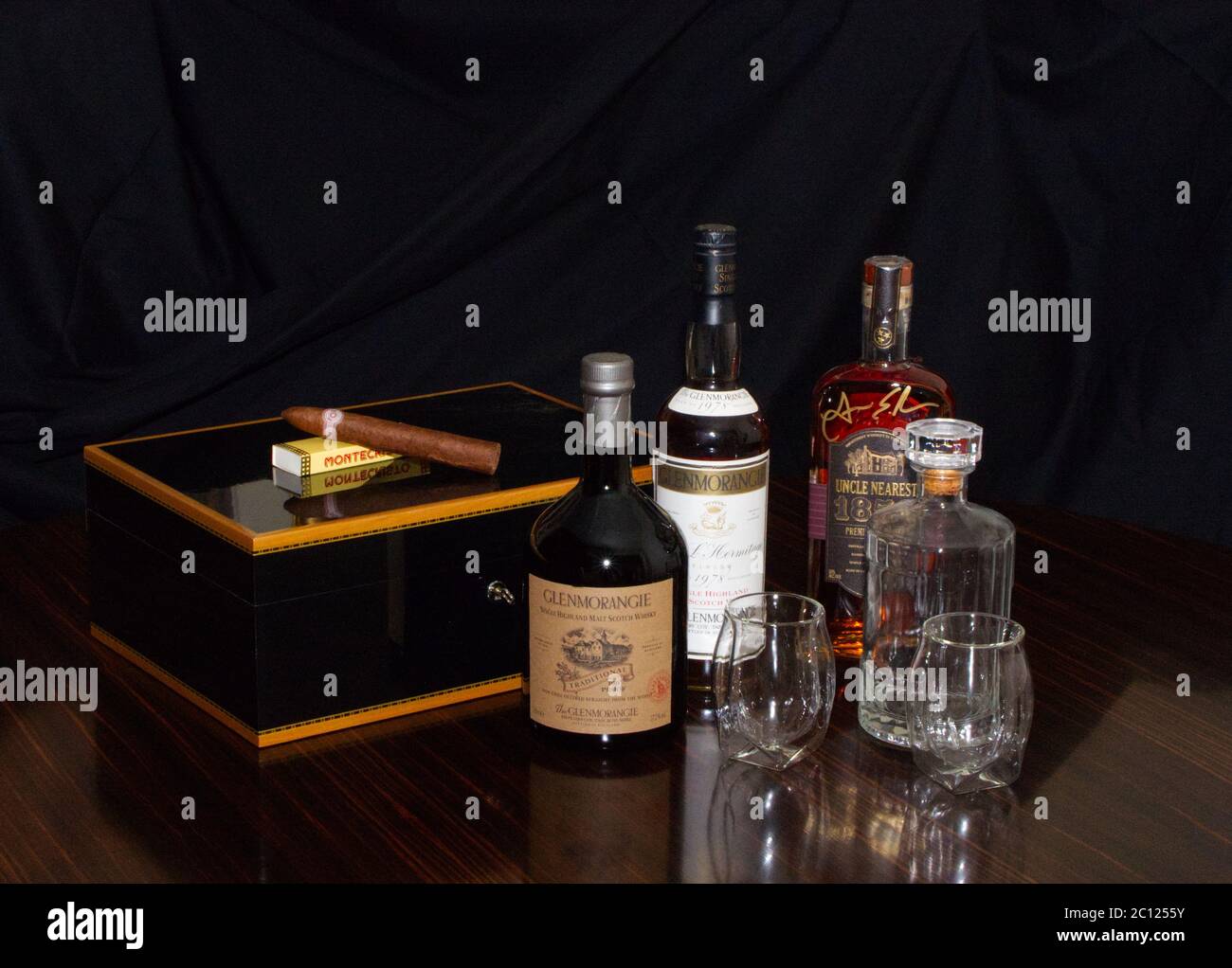 A small part of a fine Malt Whiskey collection, glasses and decanters,  Cigar humidor and Montecristo cigar Stock Photo - Alamy