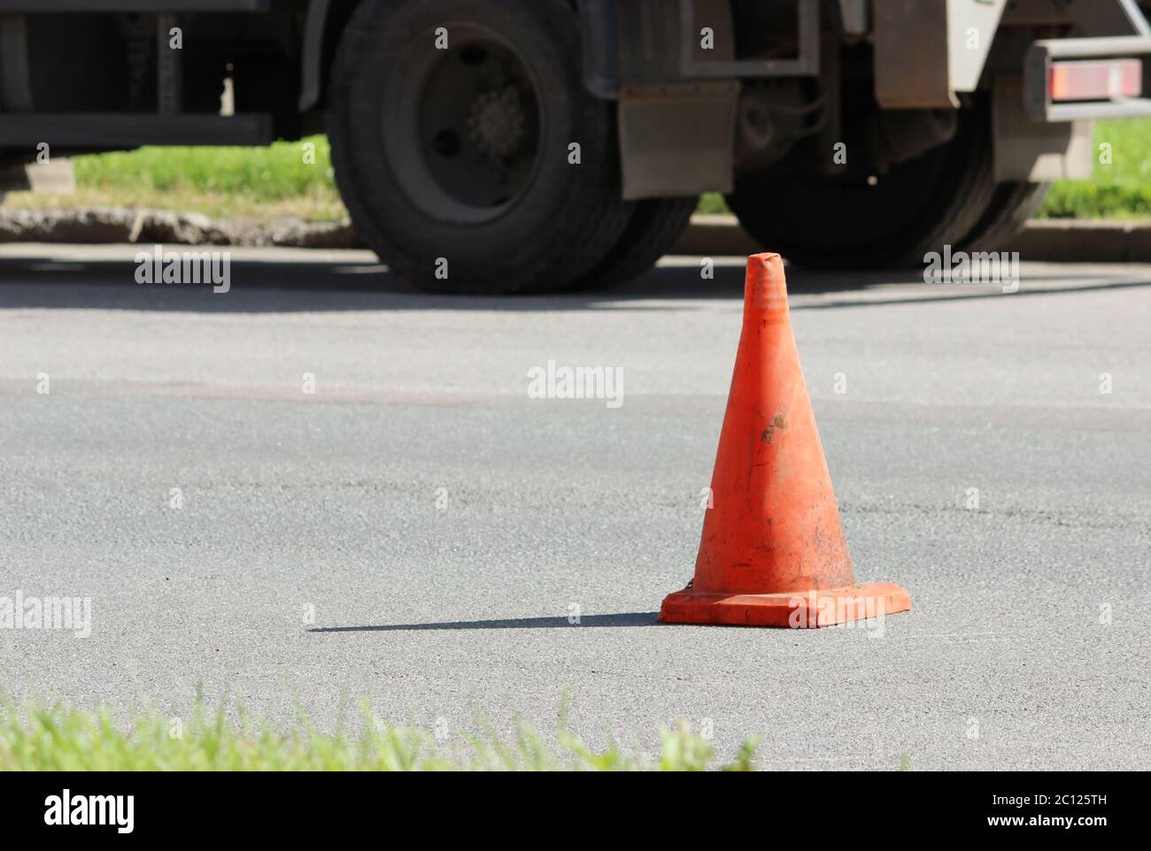plastic signaling traffic cone encloses a place in the parking lot for trucks Stock Photo