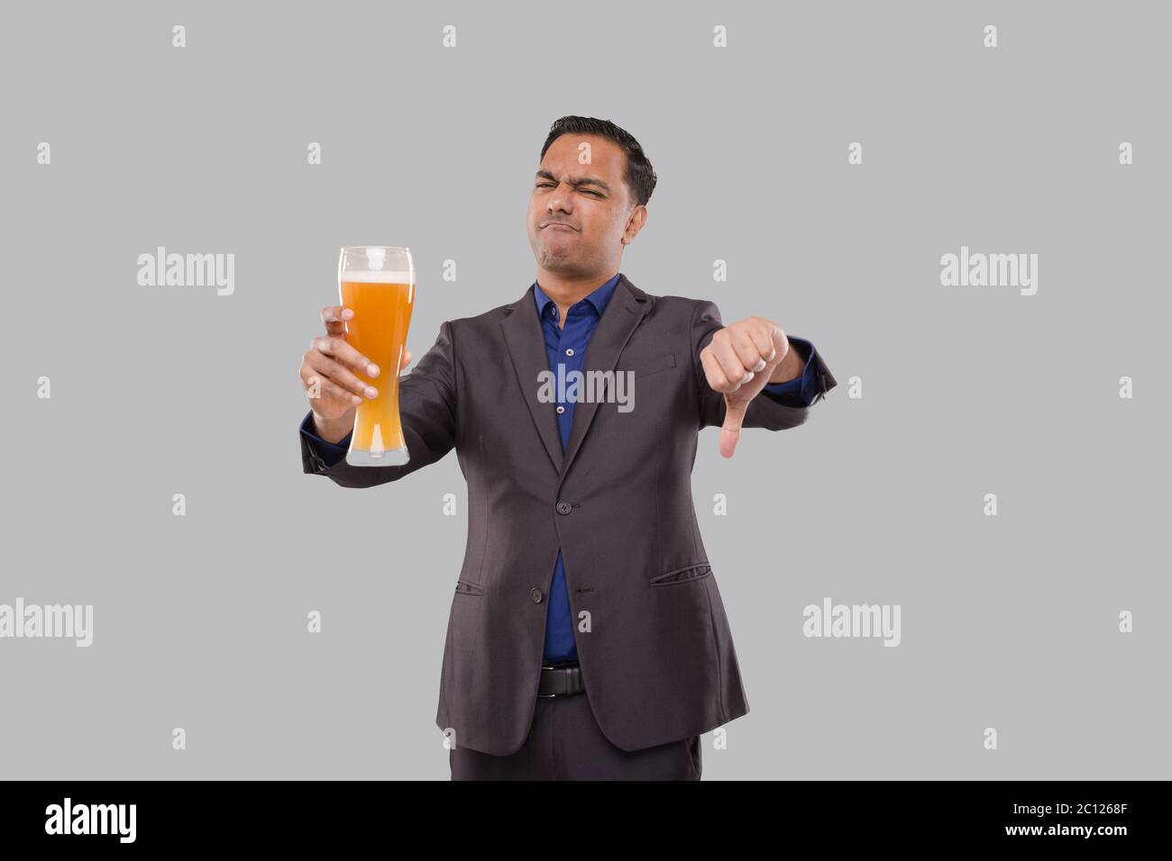 https://c8.alamy.com/comp/2C1268F/businessman-holding-beer-glass-showing-thumb-down-indian-business-man-with-beer-in-hand-2C1268F.jpg