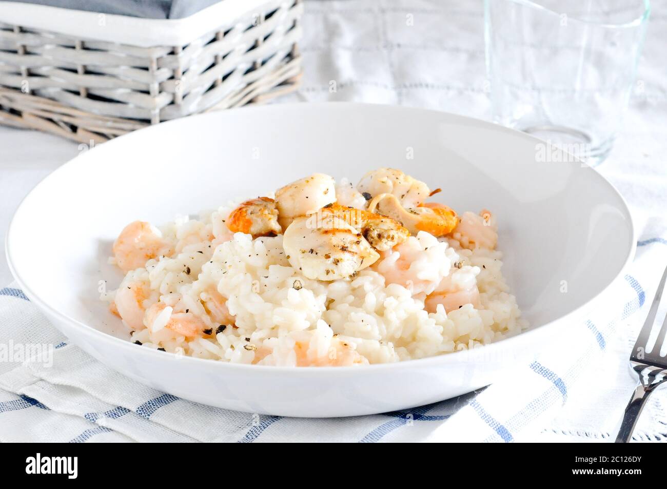 Delicious risotto with shrimp and scallops Stock Photo - Alamy