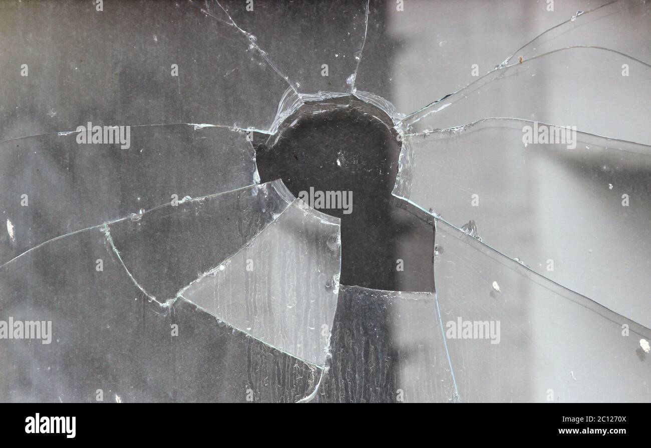 Vandals smashed the glass of the store window Stock Photo