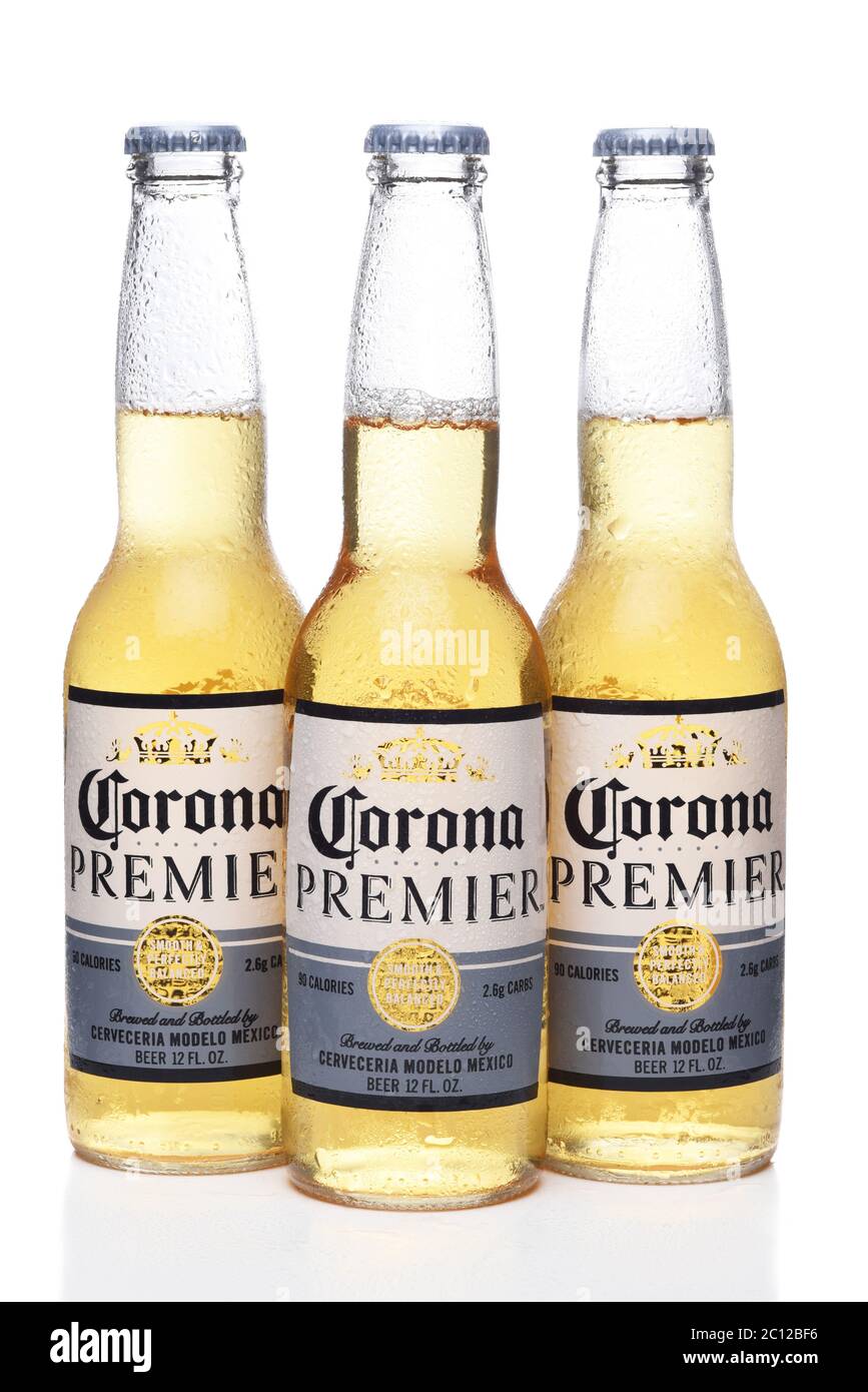 IRVINE, CALIFORNIA - 12 JUNE 2020: Three cold bottles of Corona Premier beer with condensation isolated on white with reflection. Stock Photo