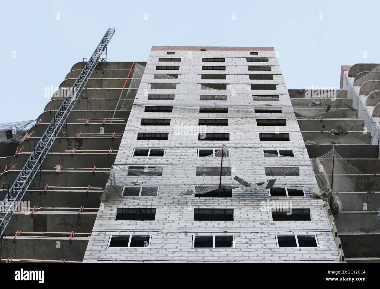 Protective catching grid net belay guard tense in the construction of a multistory newly building house. Stock Photo