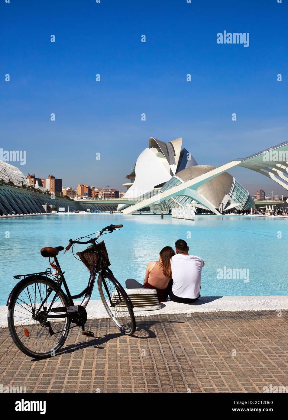Young couple sitting by a pool at the Science Park, valencia, Spain. Stock Photo