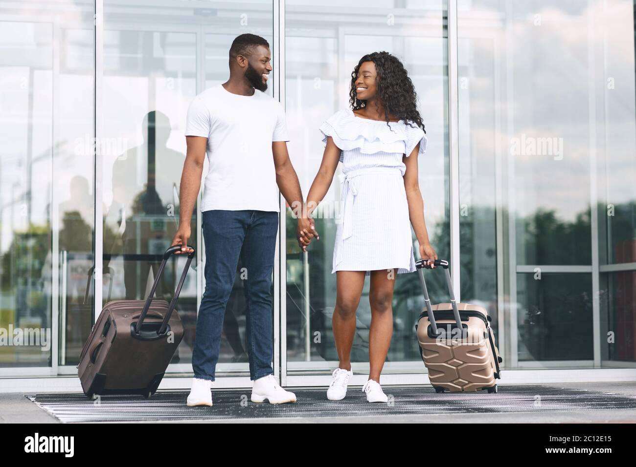 Happy Romantic African Couple Walking Out Of Airport Terminal Together ...