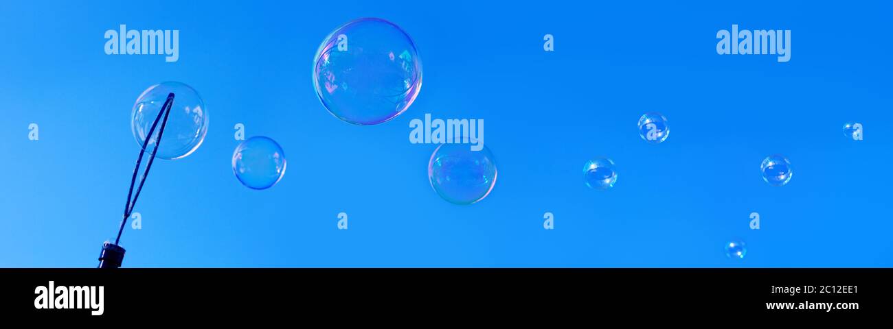 Soap bubbles against blue sky. Stock Photo