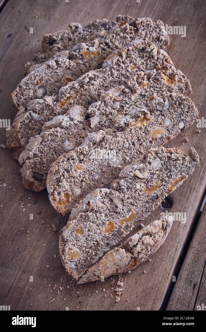 slices of rustic brown bread on a kitchen table portrait Stock Photo ...