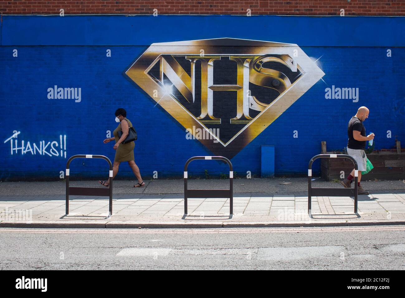 Tulse Hill, London, England. 13th June 2020. A large NHS wall mural in the form of the Superman logo painted on a blue wall in Tulse Hill in South London. (photo by Sam Mellish / Alamy Live News) Stock Photo