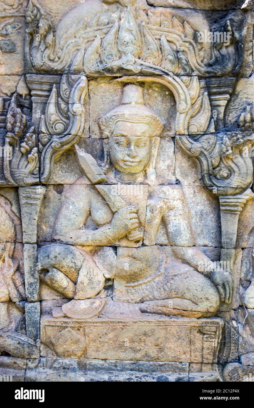 Carving of a deva, or Hindu god, holding a sword. Terrace of the Leper King, Angkor Thom, Cambodia. Stock Photo