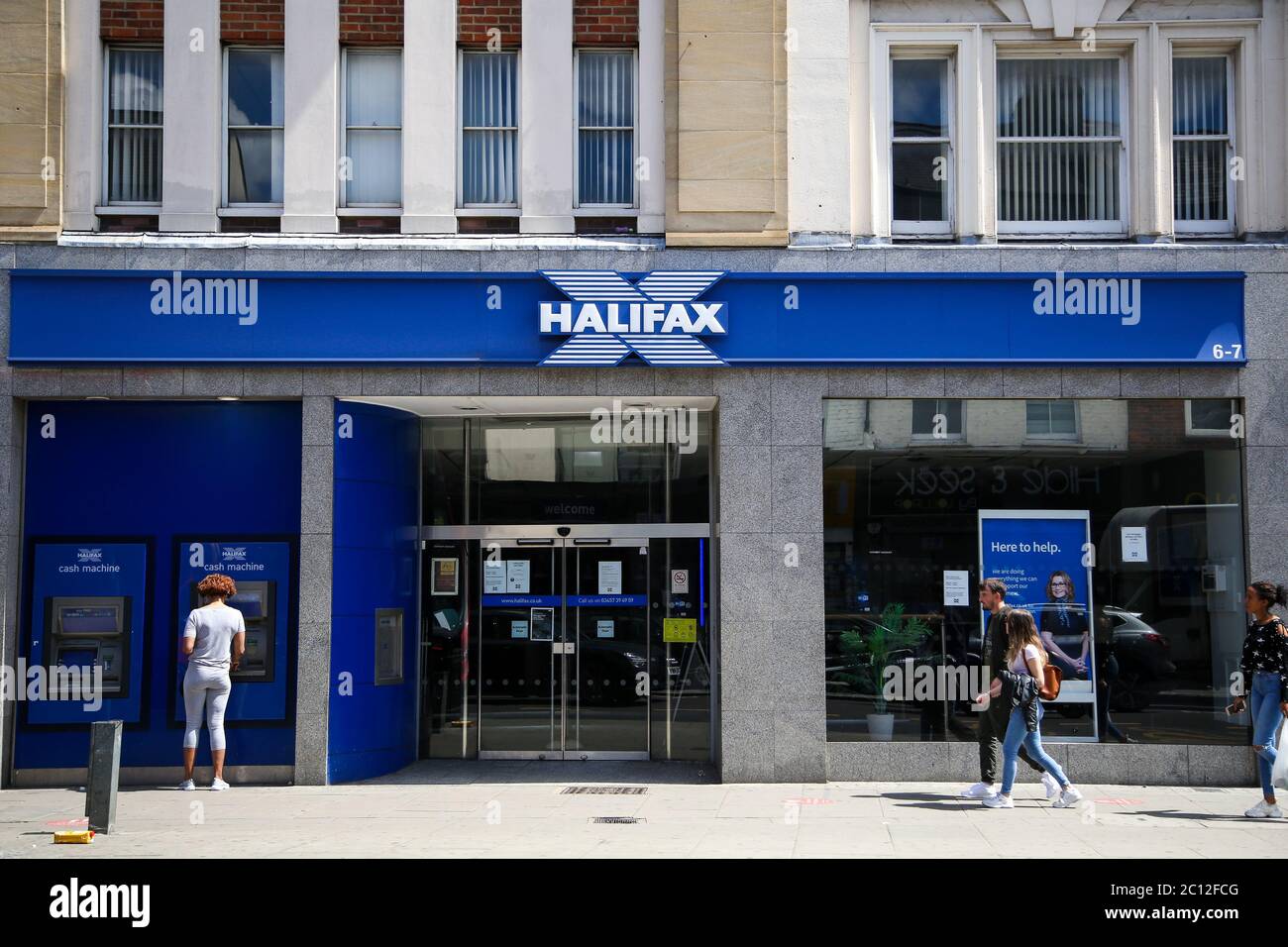 People walk past a branch of Halifax bank in London Stock Photo Alamy