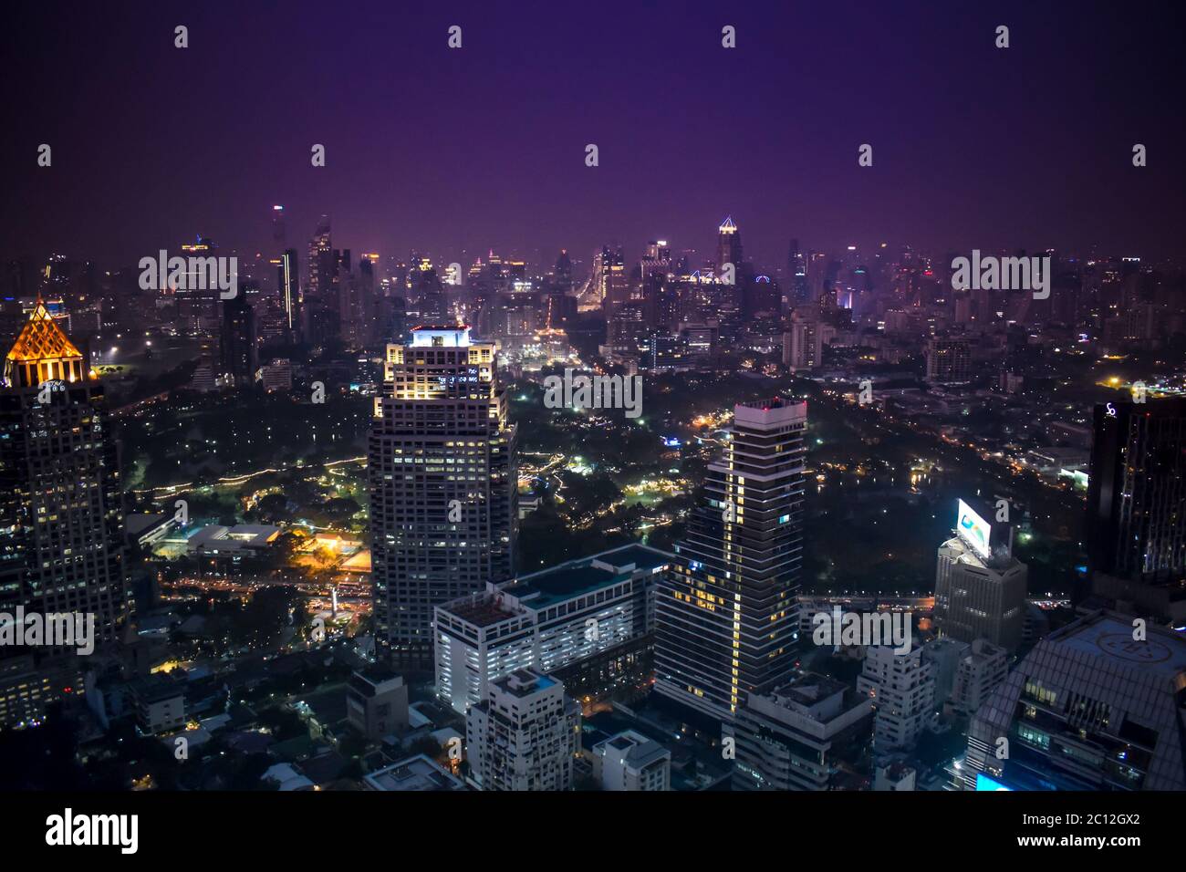 The enlightened skyscrapers of metropolitan Bangkok skyline during night in Thailand Stock Photo