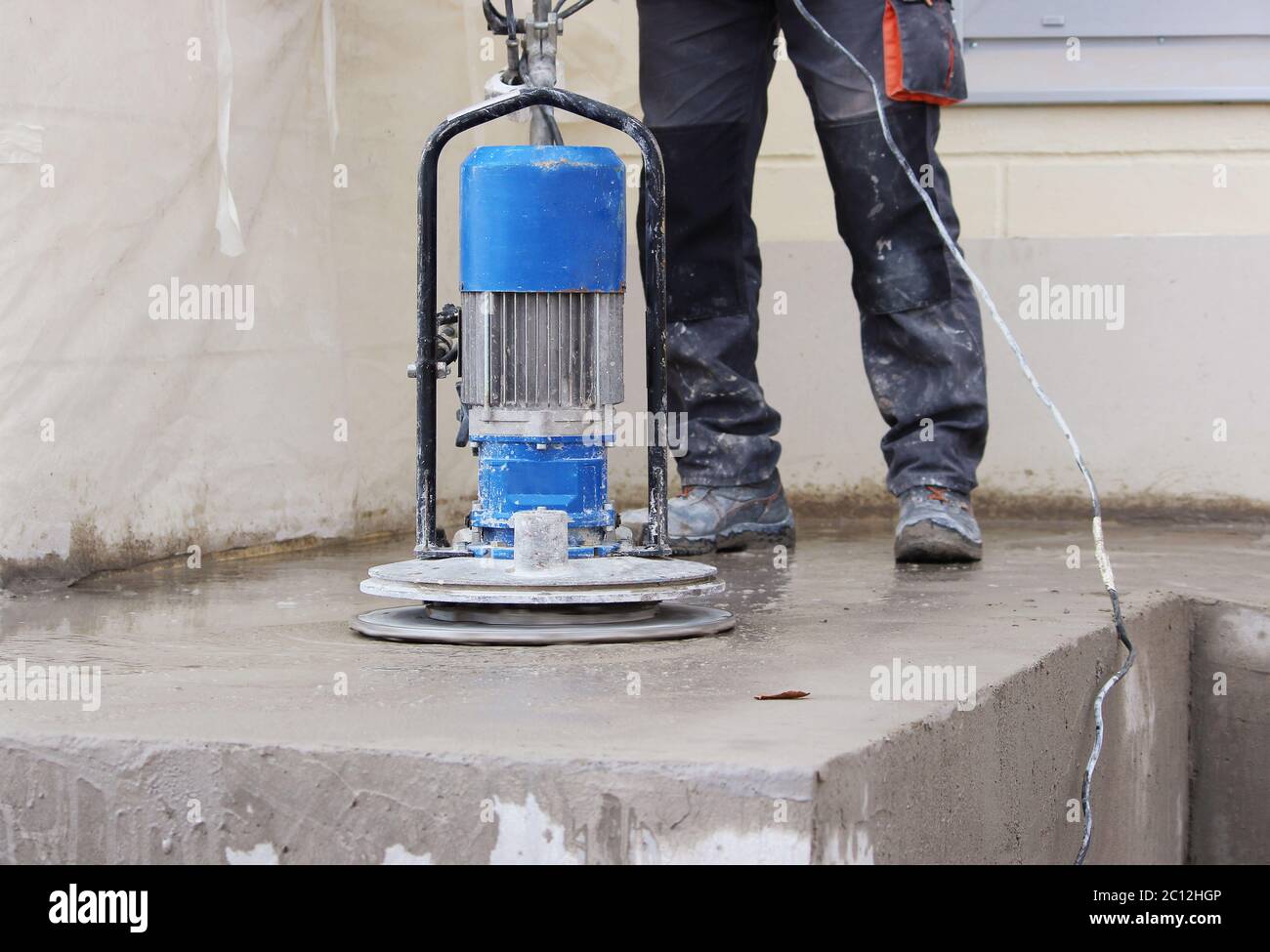male worker works with the diamond grinding machine, polishing the