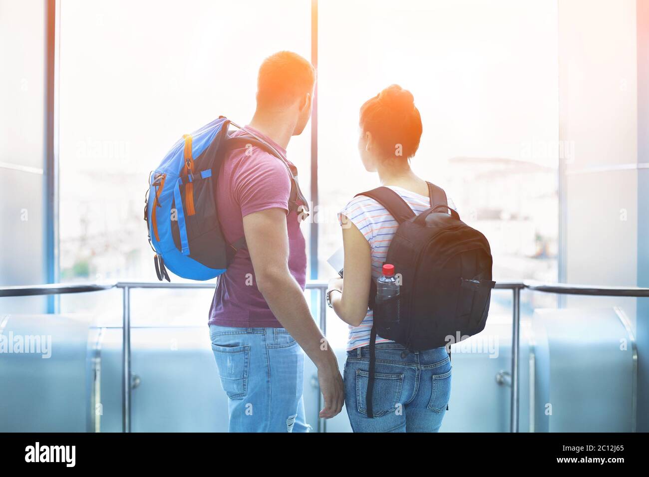 Traveler couple in love with backpacks indoors Stock Photo