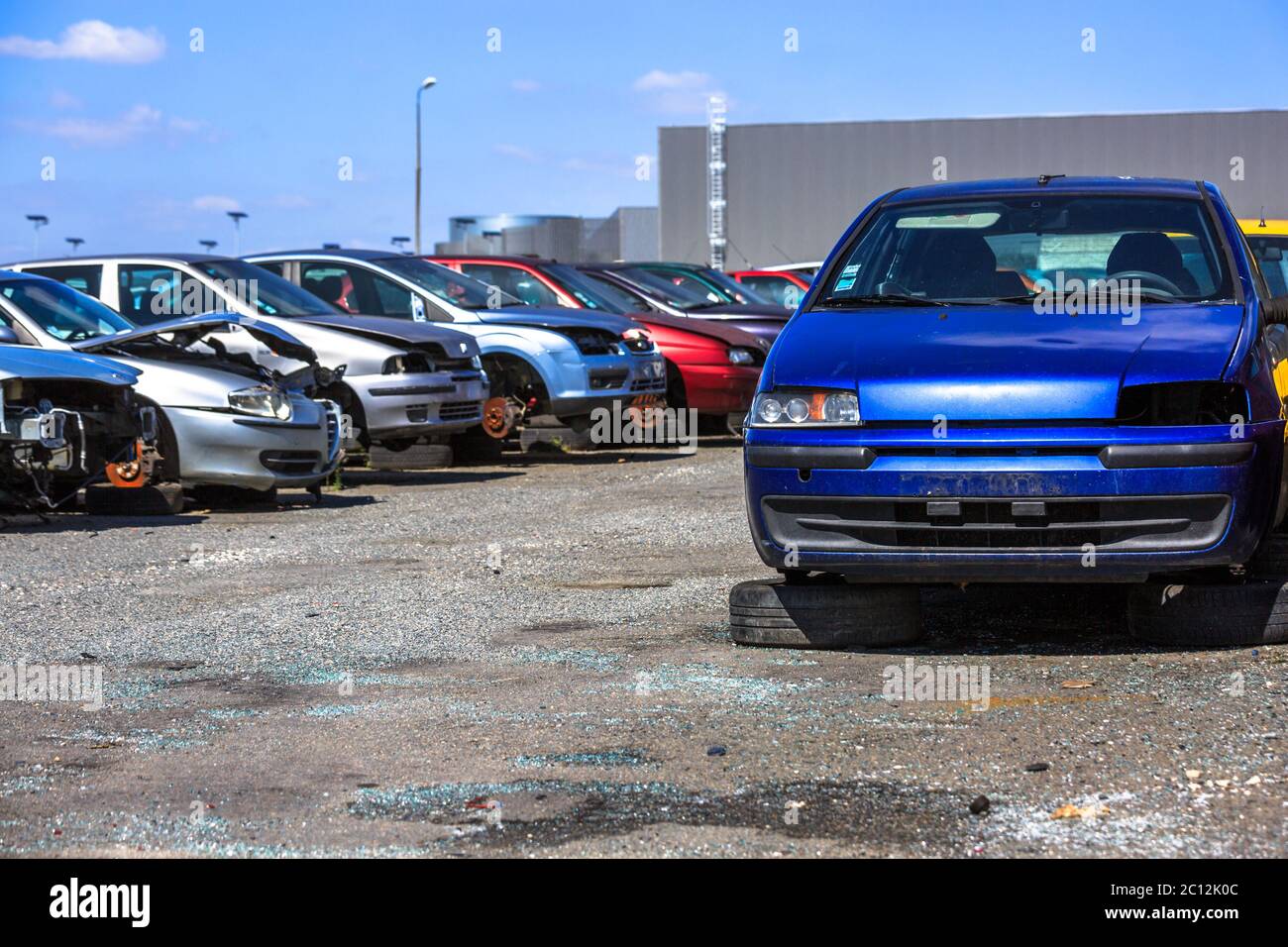 several cars in a scrap yard available for spare parts Stock Photo