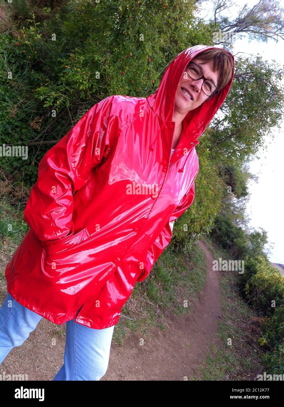 Smiling woman under a heavy rain, Brittany, France Stock Photo