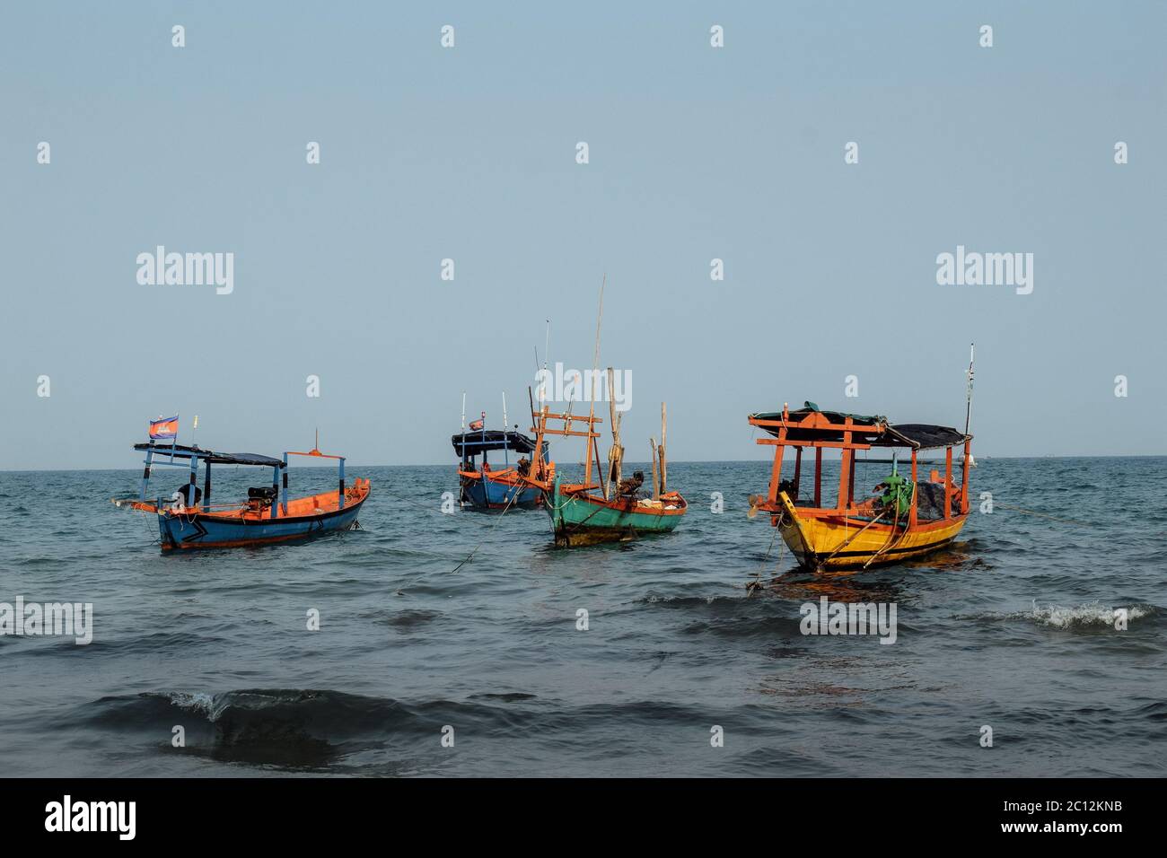 Fisherman boats docking by a tropical Island in Cambodia Stock Photo