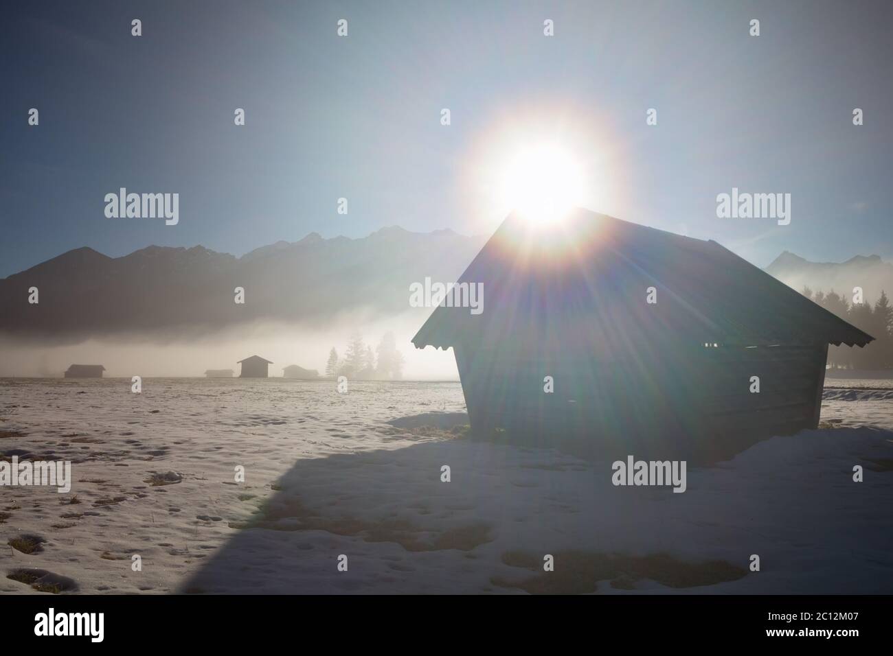 sunshine over wooden hut in Alps Stock Photo