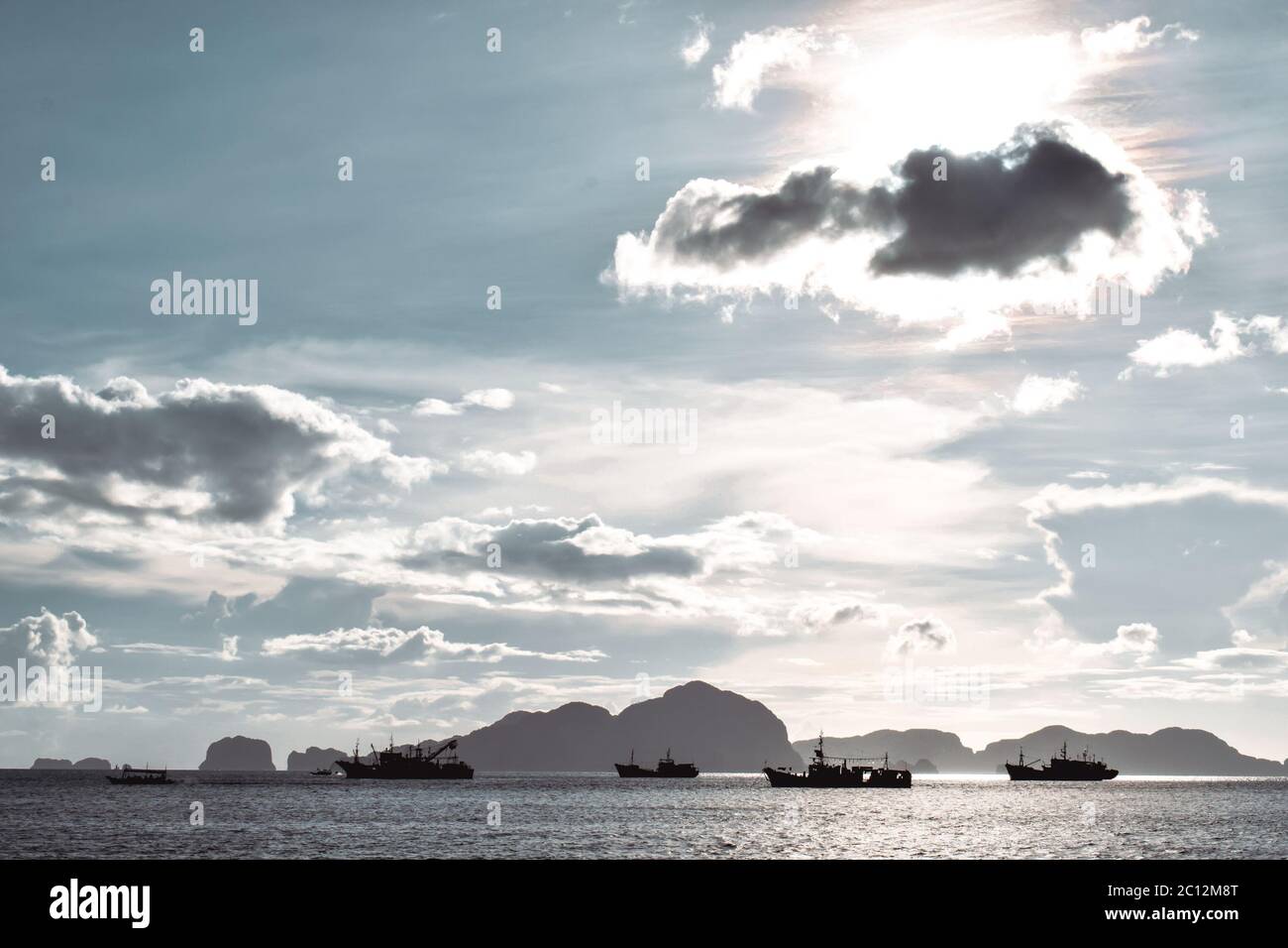 Fisherman ships cruising the sea in El Nido the Philippines under clear blue sky on a sunny day Stock Photo