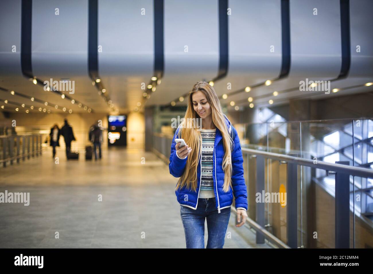 Young woman in international airport Stock Photo - Alamy