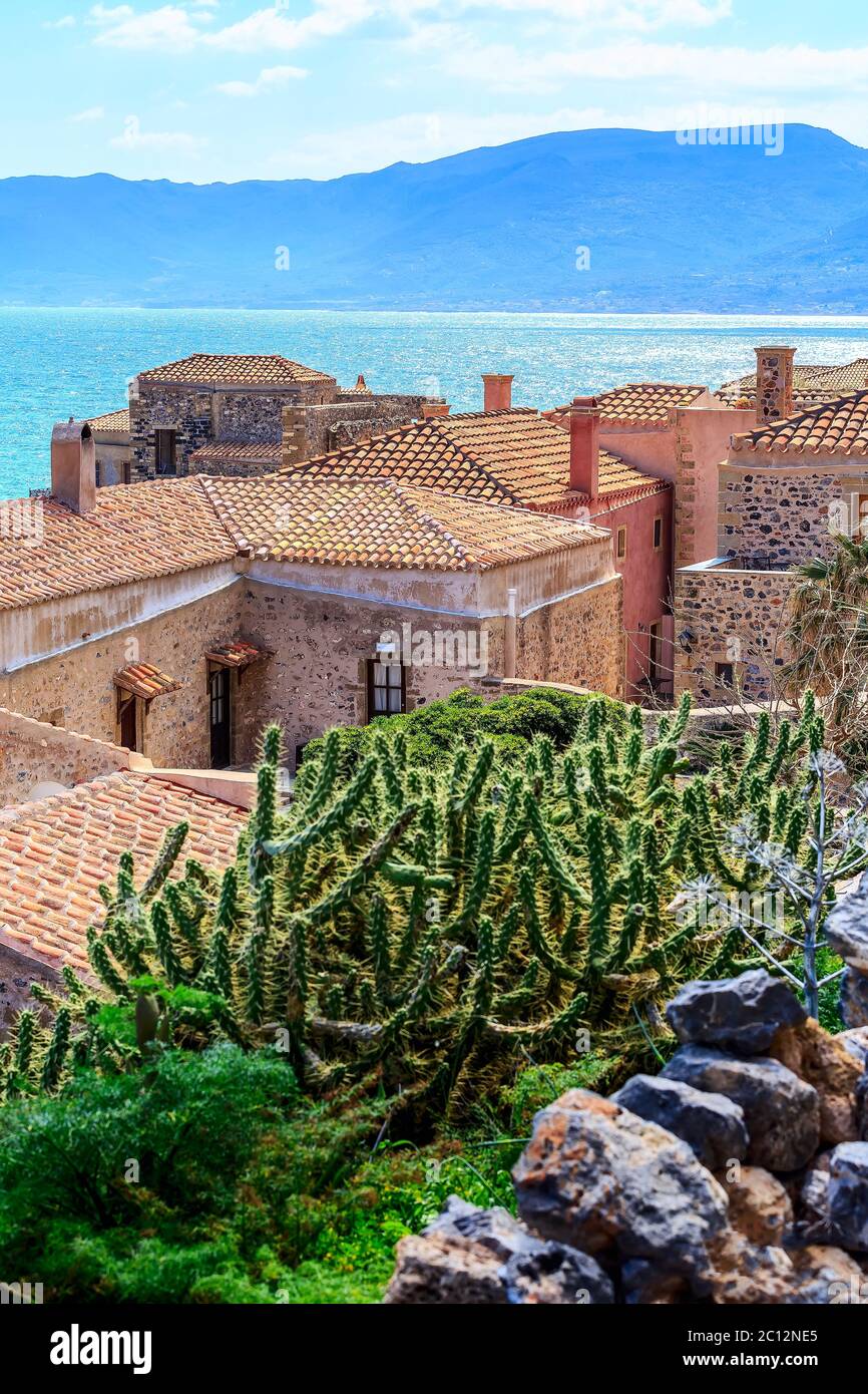 Monemvasia church, old red brick houses, roofs in ancient town and blue sea view, Peloponnese, Greece. Traditional greek architecture background Stock Photo