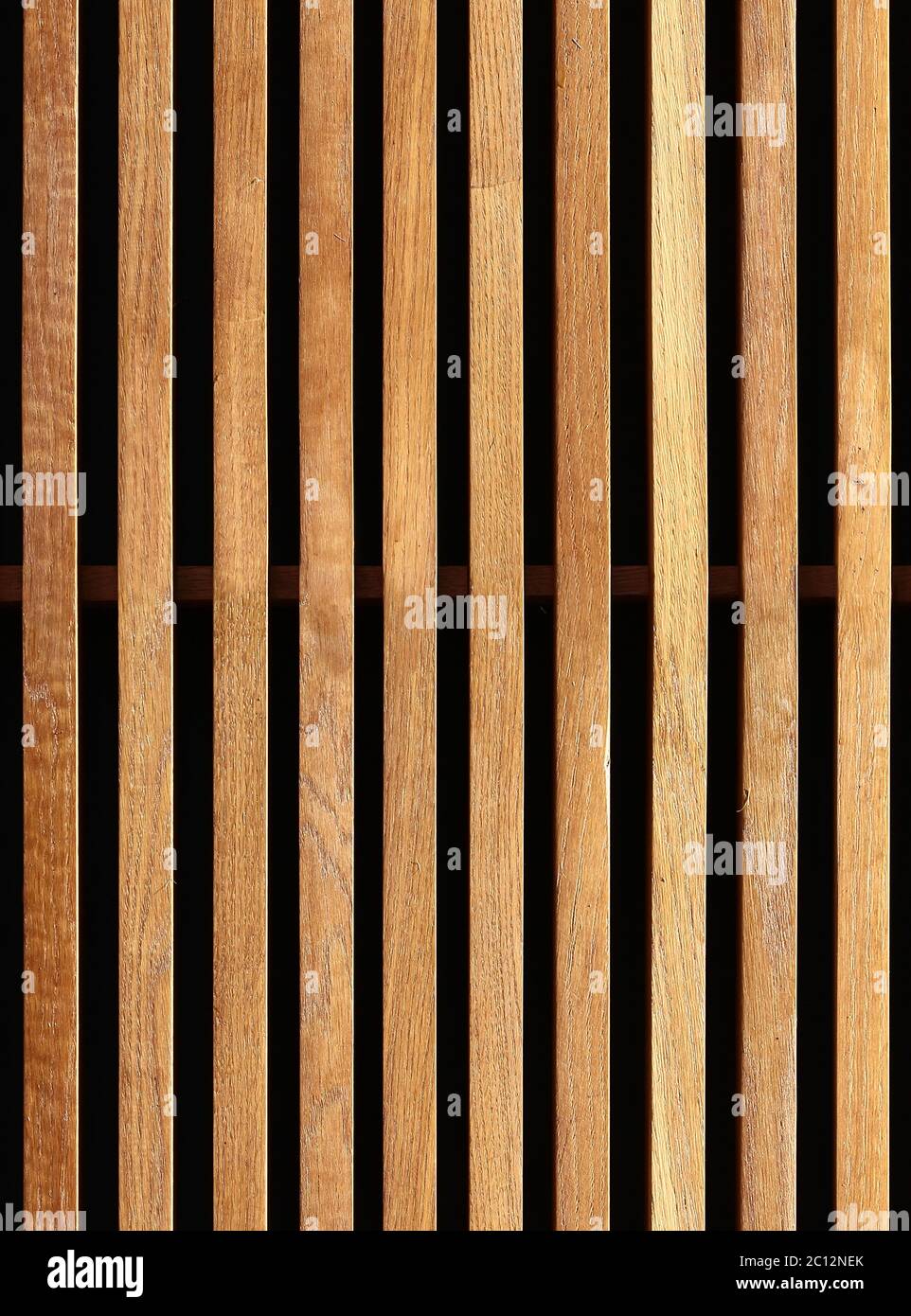 Seamless texture of wooden decorative battens placed vertically on