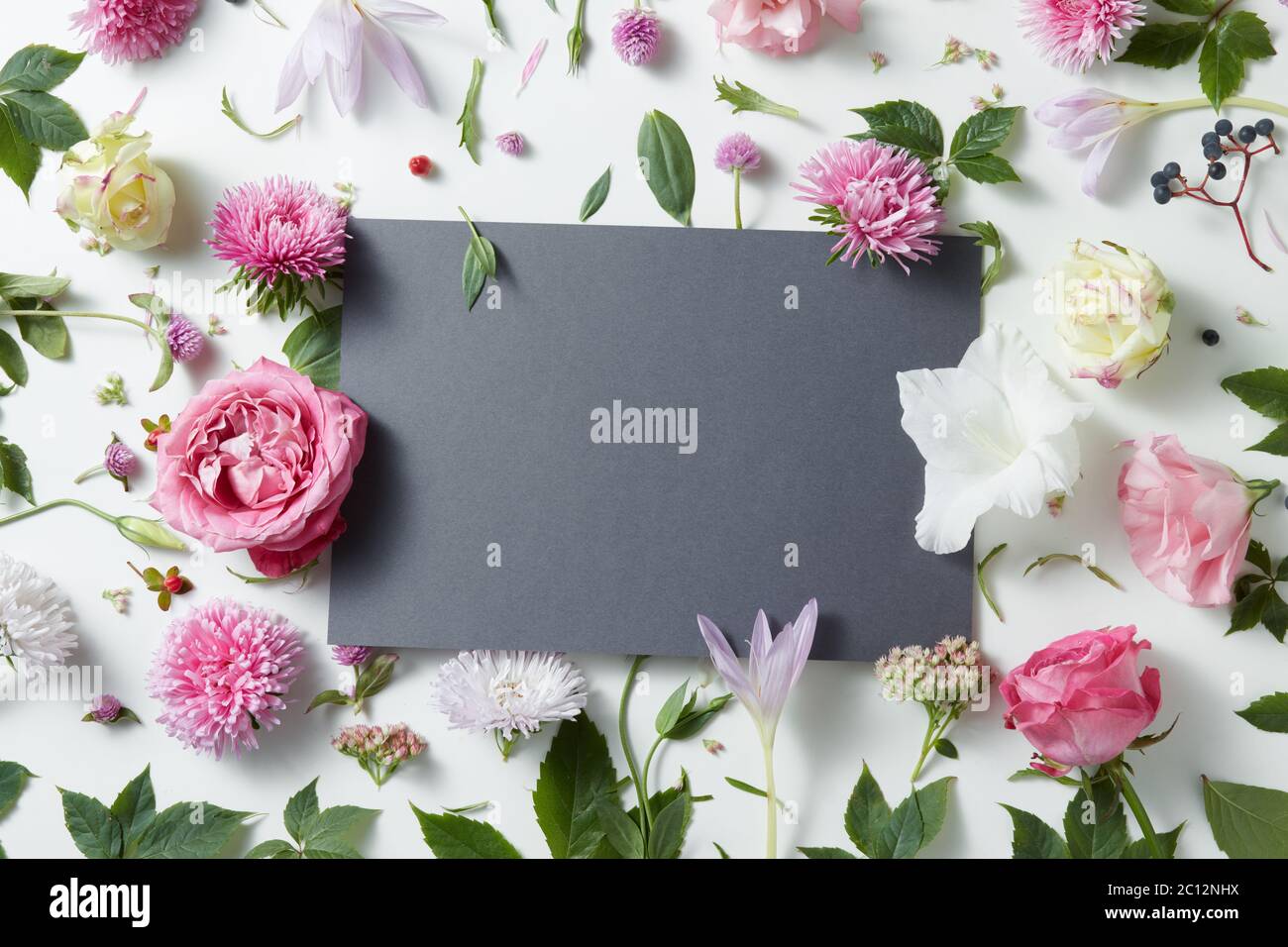 Beautiful pink and white flowers with empty notebook Stock Photo