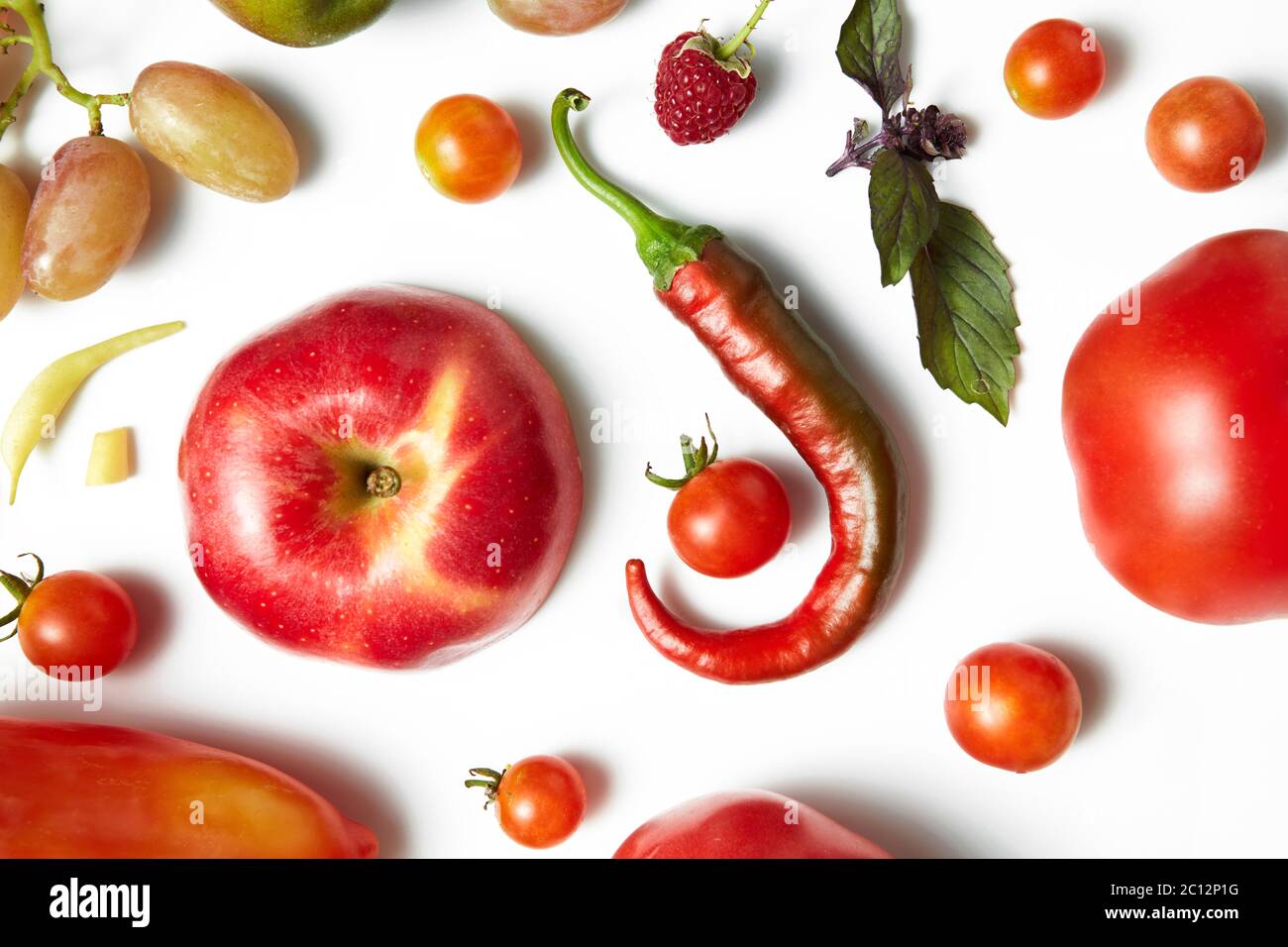 Red chili pepper and tomato on white background . Organic pattern. Stock Photo