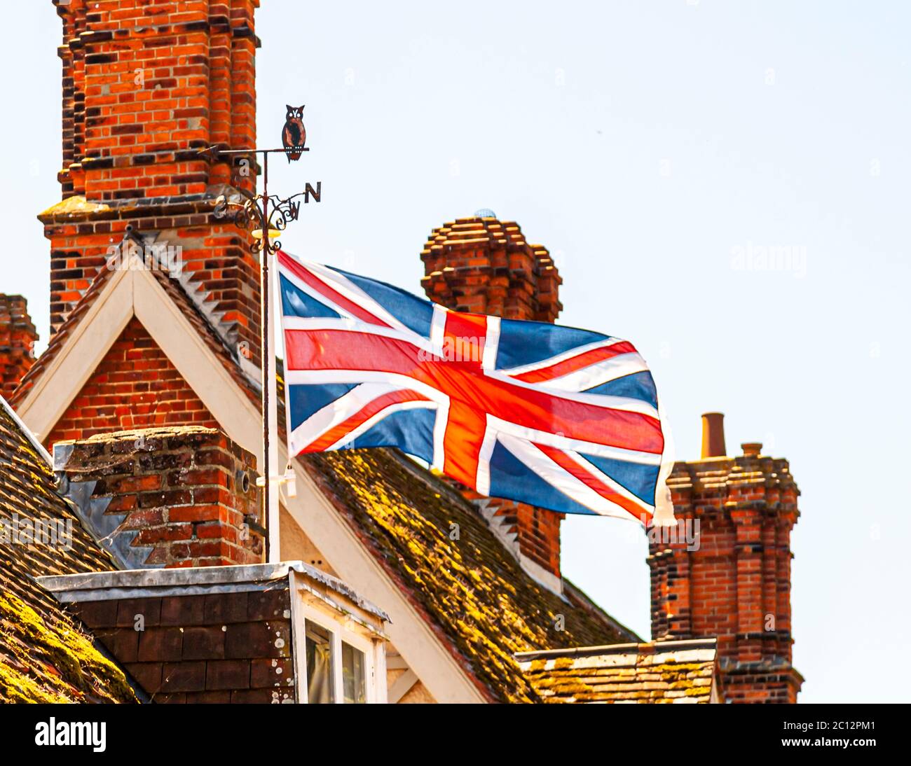 Roofs with chimneys and Union Jack flag in East Suffolk, England Stock Photo