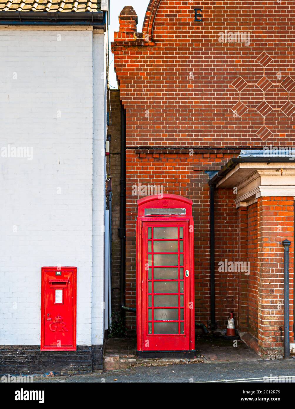 Red mailbox and red phone booth in East Suffolk, England Stock Photo