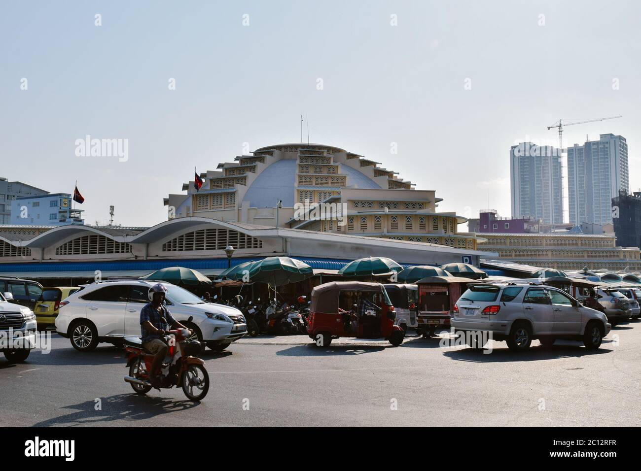 Cars passing around the Phnom Penh Central Market in Cambodia Stock Photo