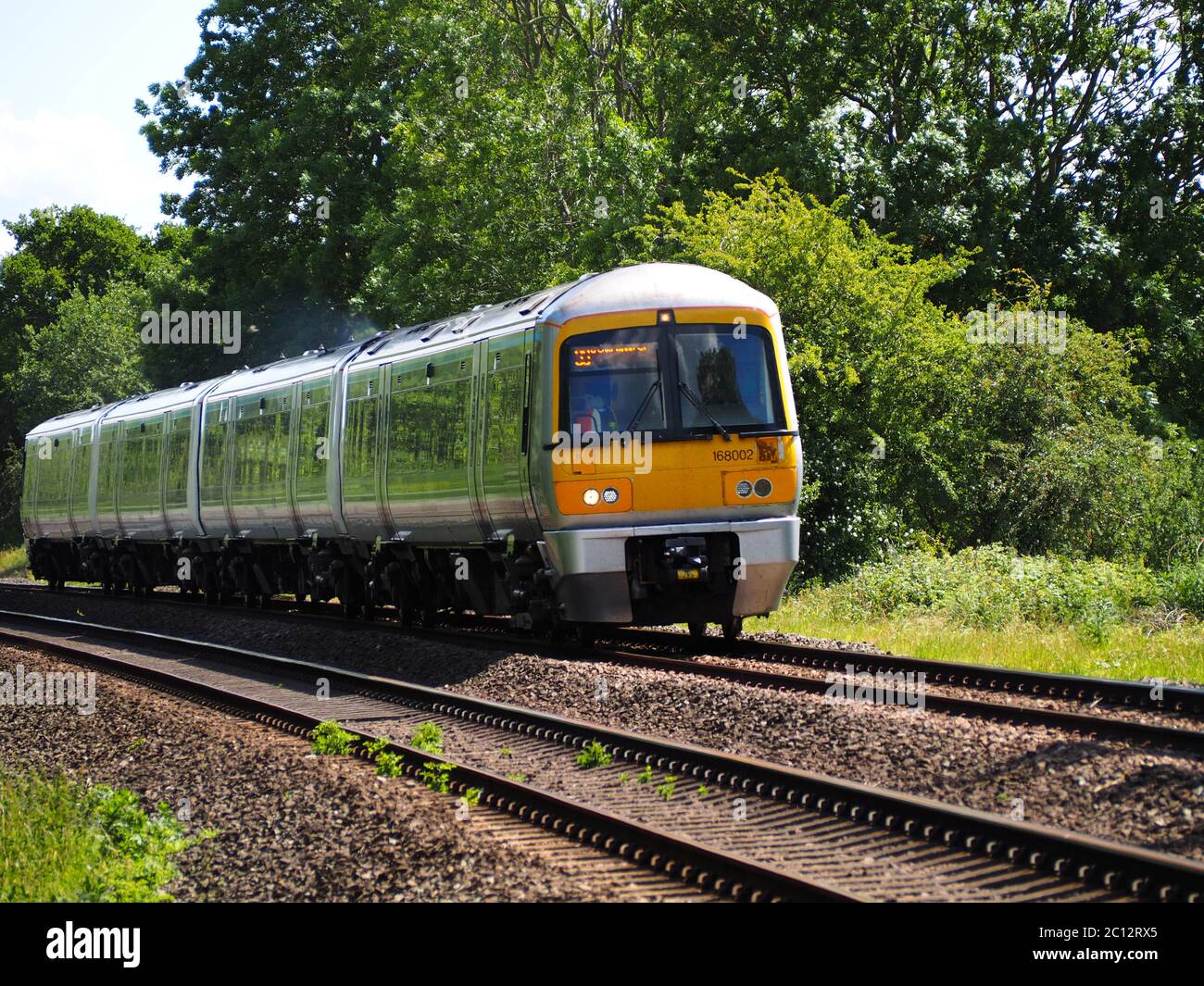 Chiltern Railways by Arriva Class 168 Clubman passes Claydon in Oxfordshire on the way from London Marylebone to Birmingham Moor Street Stock Photo