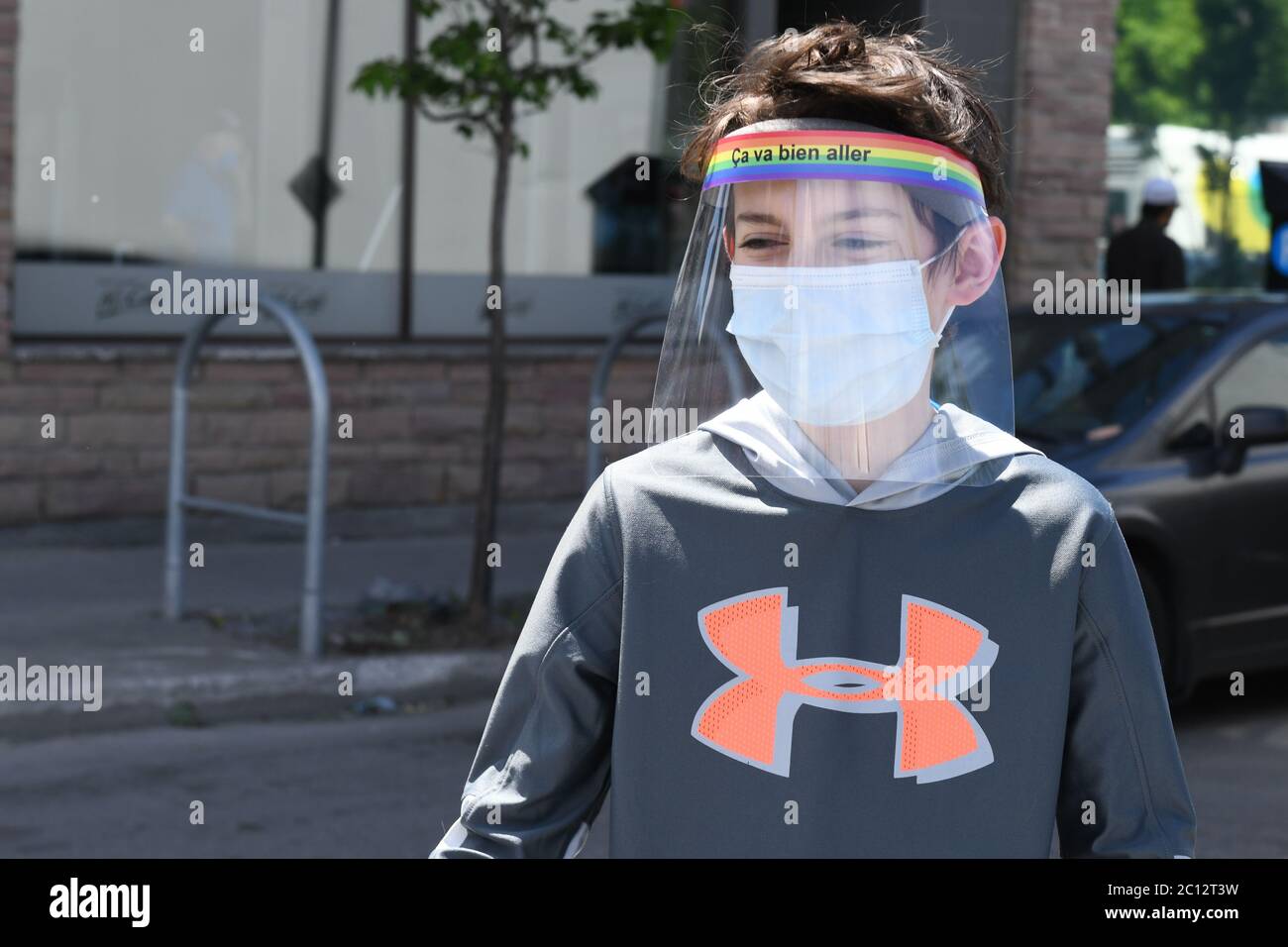 Boy wearing protective face masks and face shields during Covid-19 Pandemic in Montreal Canada (Model released) Stock Photo