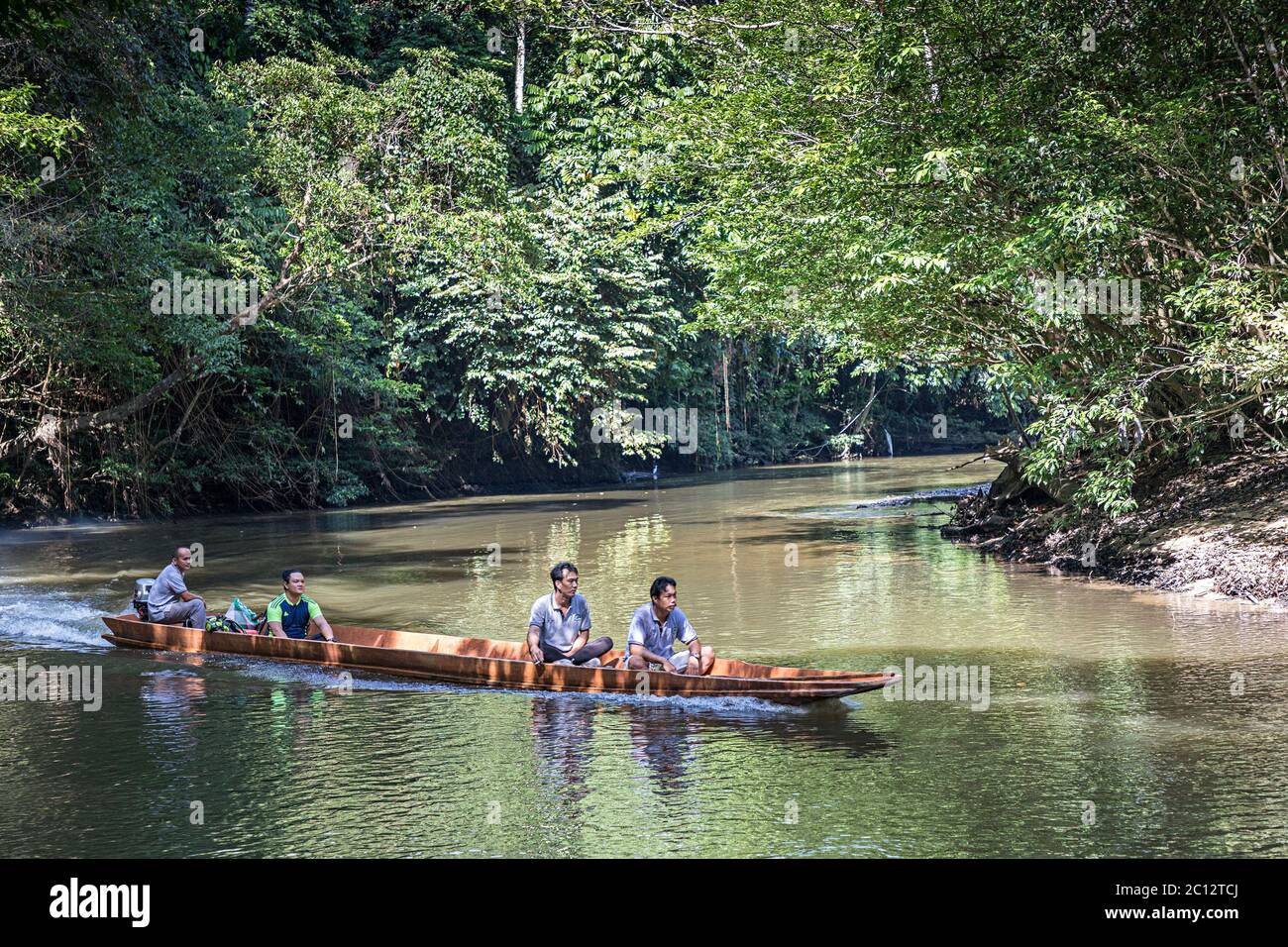 Local villagers using a boat for travel on the Melinau River, Mulu, Malaysia Stock Photo