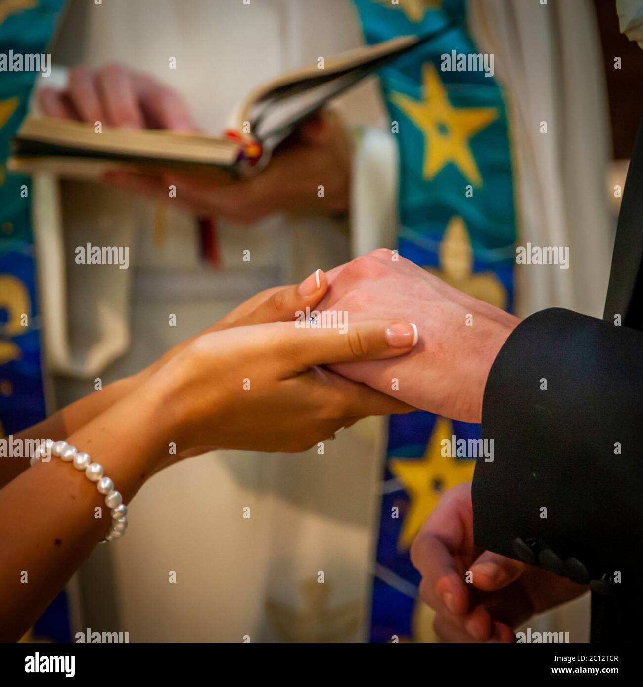 Exchange of bridal rings during the Anglican service. British Wedding in South Cambridgeshire, England Stock Photo