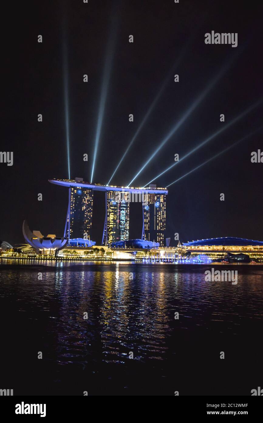 Evening lights show at Marina Bay Sands Hotel in Singapore reflected in the water of the Bay Stock Photo