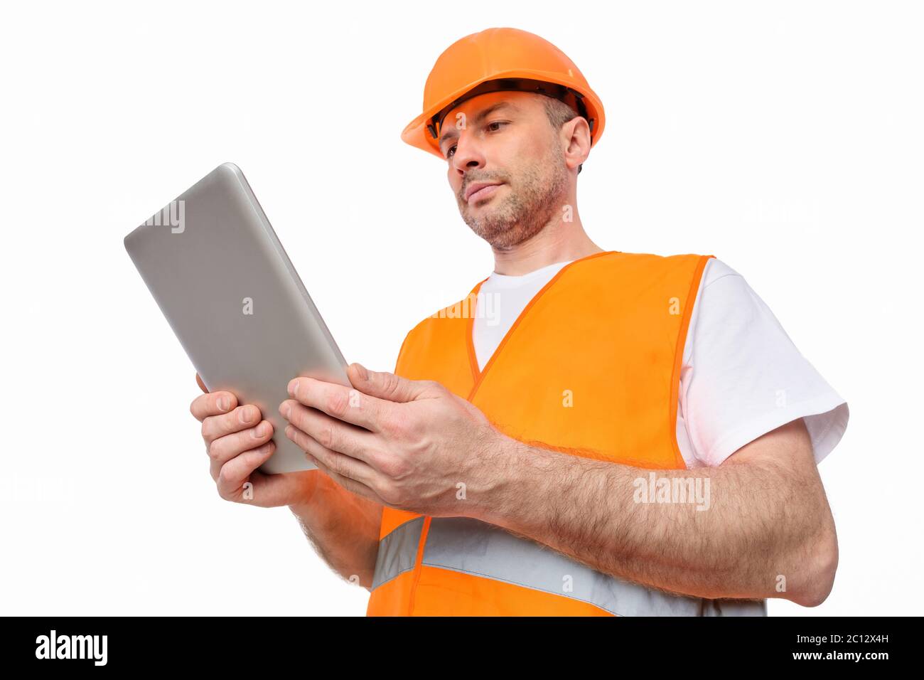 Serious Architect Using Digital Tablet Standing On White Studio Background Stock Photo