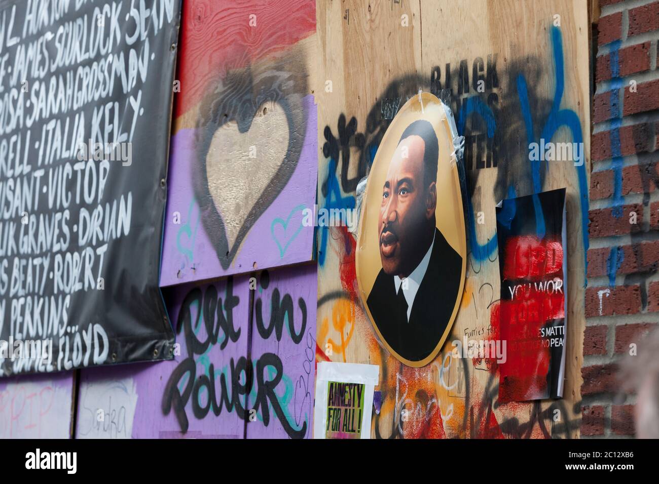 An image of Martin Luther King Jr. adorns a growing shrine to George Floyd in the “Capitol Hill Autonomous Zone” in Seattle on Friday, June 12, 2020. The zone, also known as CHAZ, is a self-declared intentional community and commune established when the Seattle Police Department closed the East Precinct after days of large protests and occasional violent clashes. Stock Photo