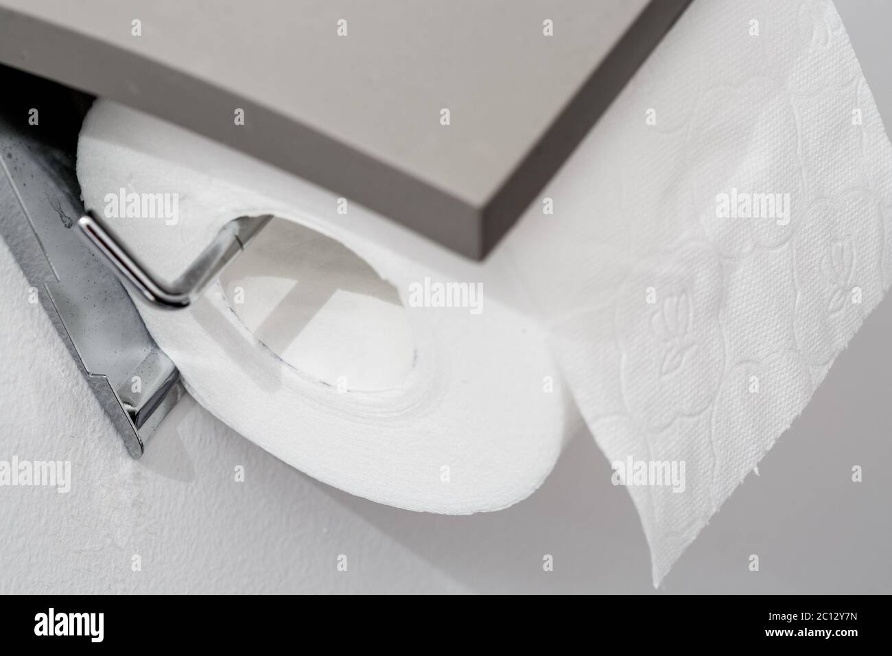 Toilet paper roll on wall of modern white bathroom Stock Photo Alamy
