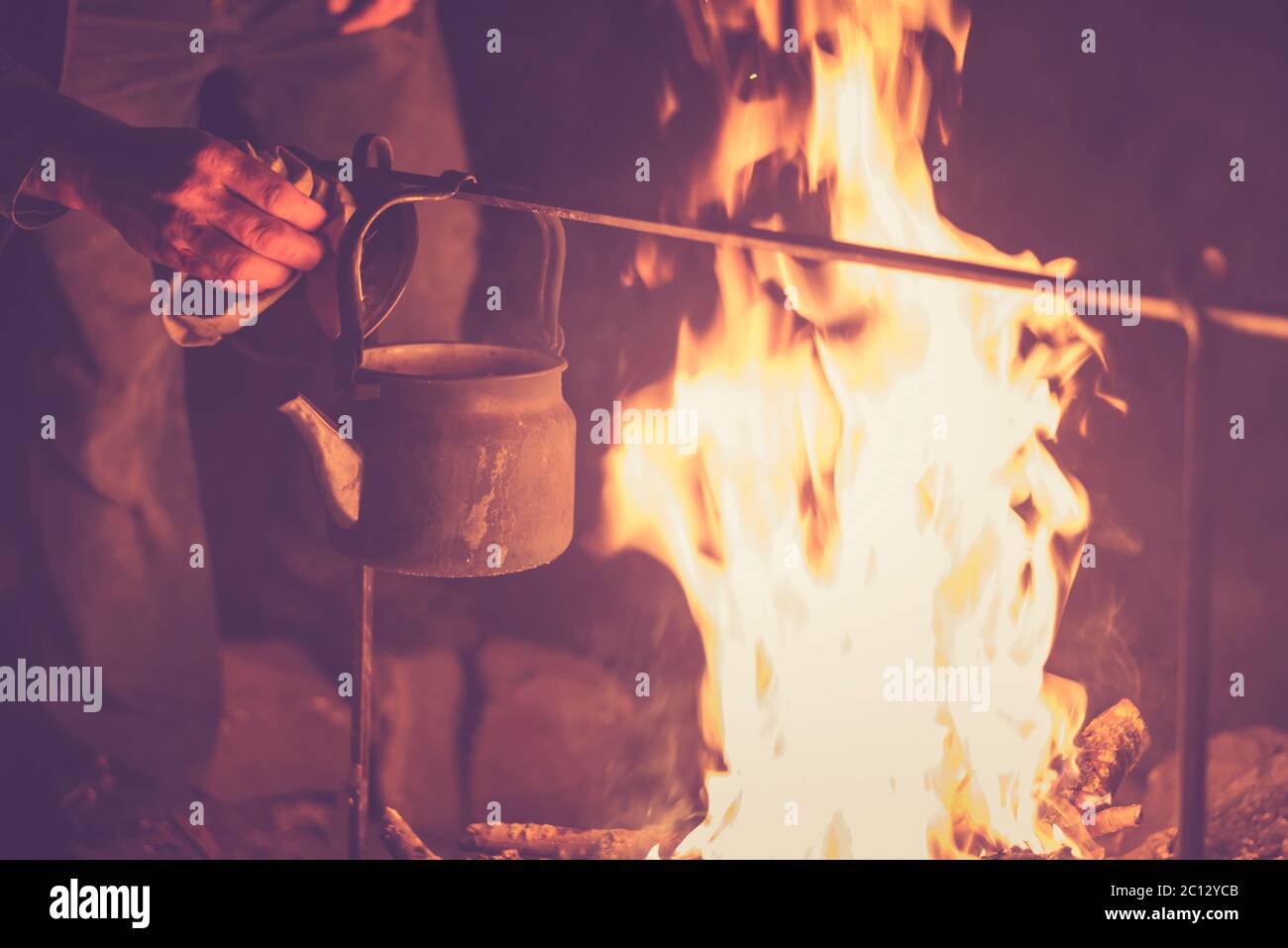 Kettle with water heated on the fire Stock Photo - Alamy
