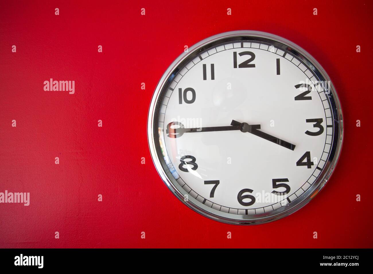 modern big clock on red wall Stock Photo Alamy